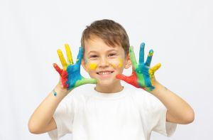 happy kid with paints hands