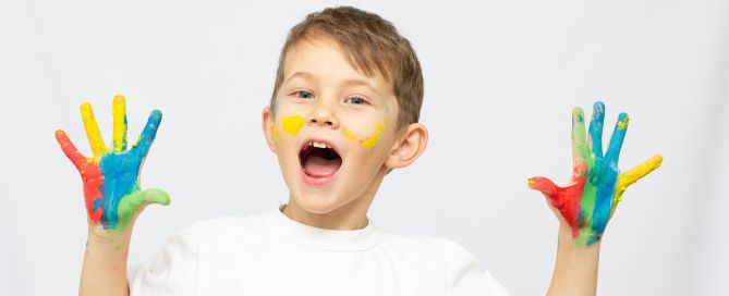 Leads Early Smiling Boy With Hands Paint White Background Scaled